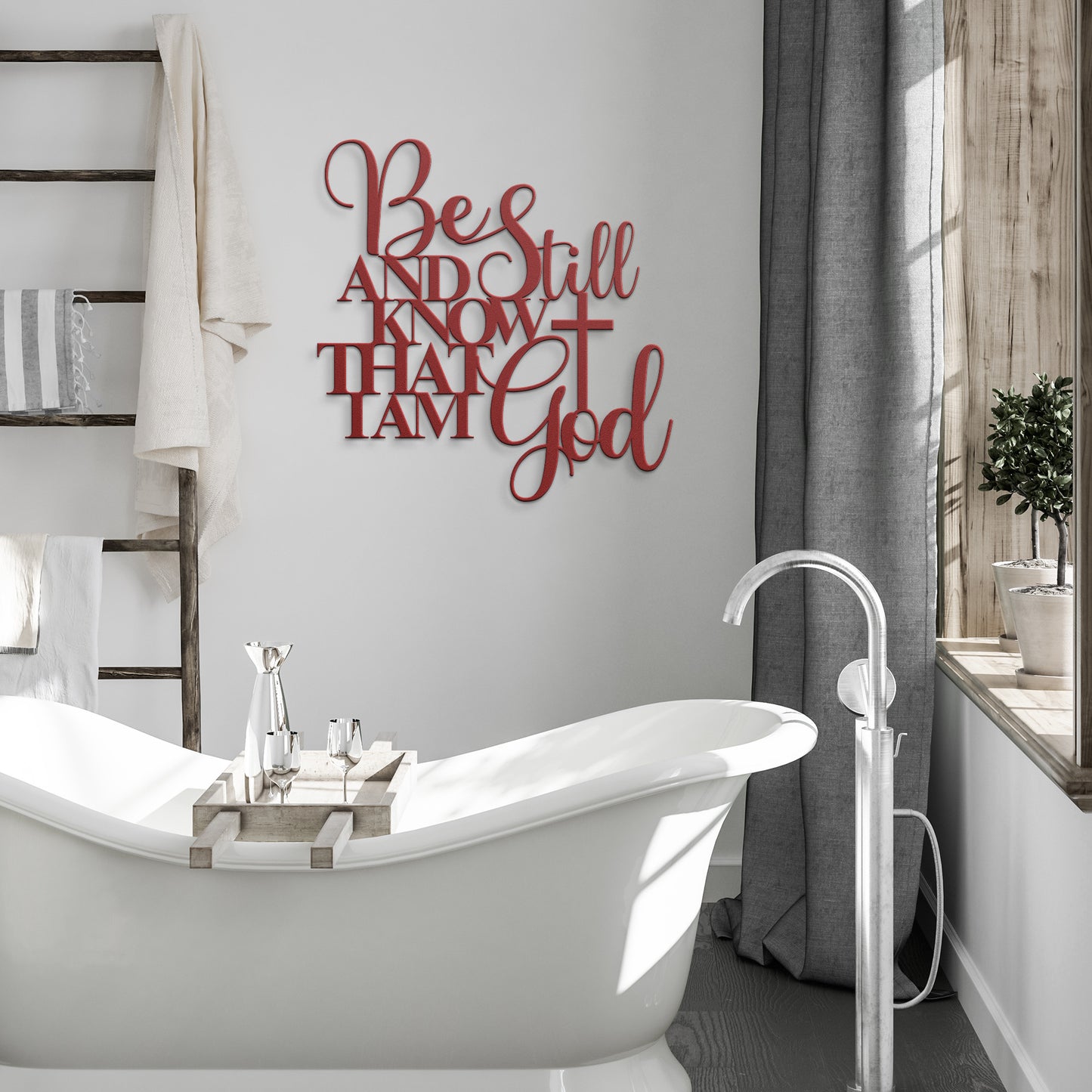 Minimalist bathroom featuring a freestanding tub, a wooden ladder shelf with towels, and a sophisticated home decor touch—a red Be Still And Know Christian Metal Art sign. Gray curtains hang beside a large window.