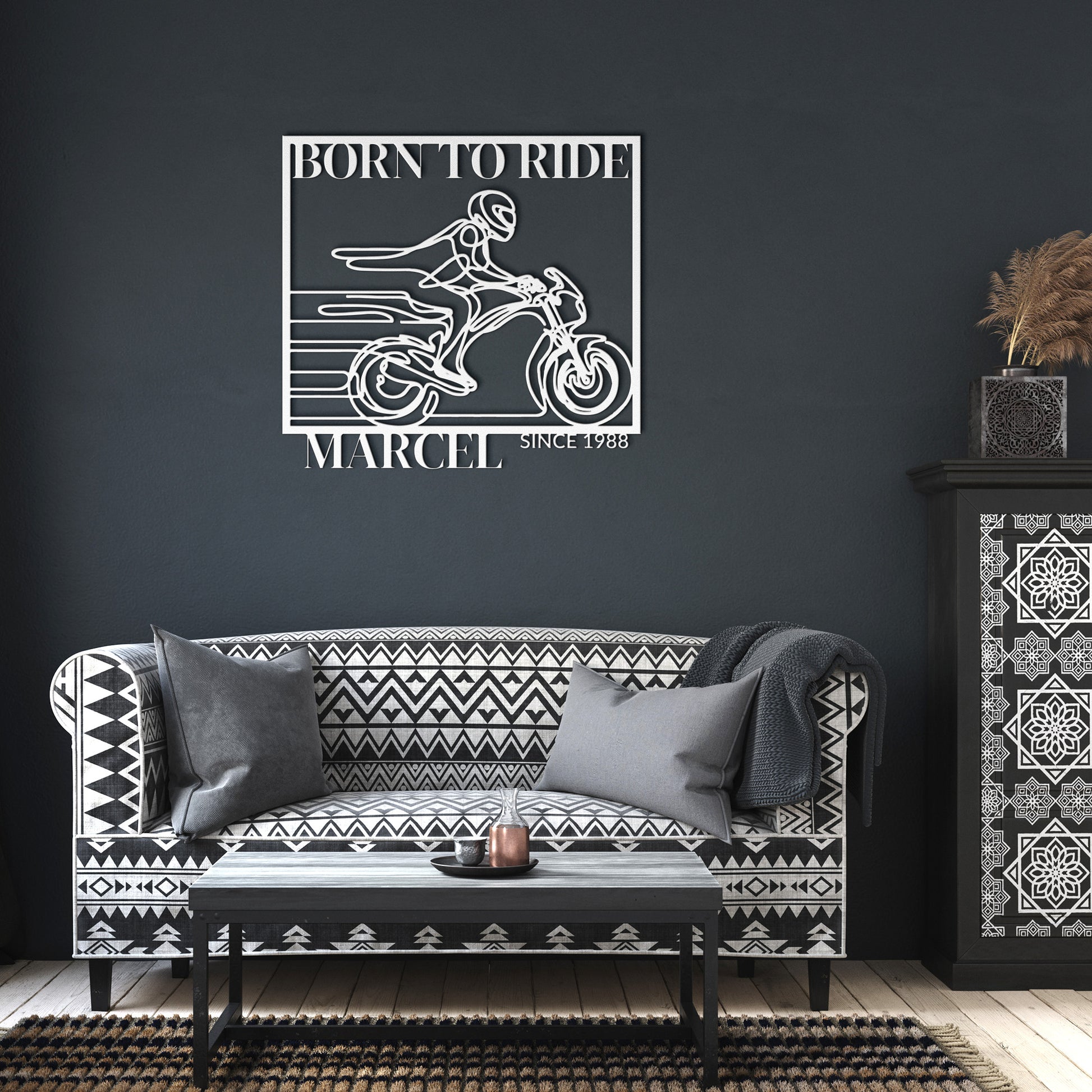 The Biking Metal Line Art, featuring a motorcyclist with the text "Born to Ride Marcel Since 1988," makes for a stunning home decor piece. Crafted from durable 18 gauge steel, this metal sign is built to last.