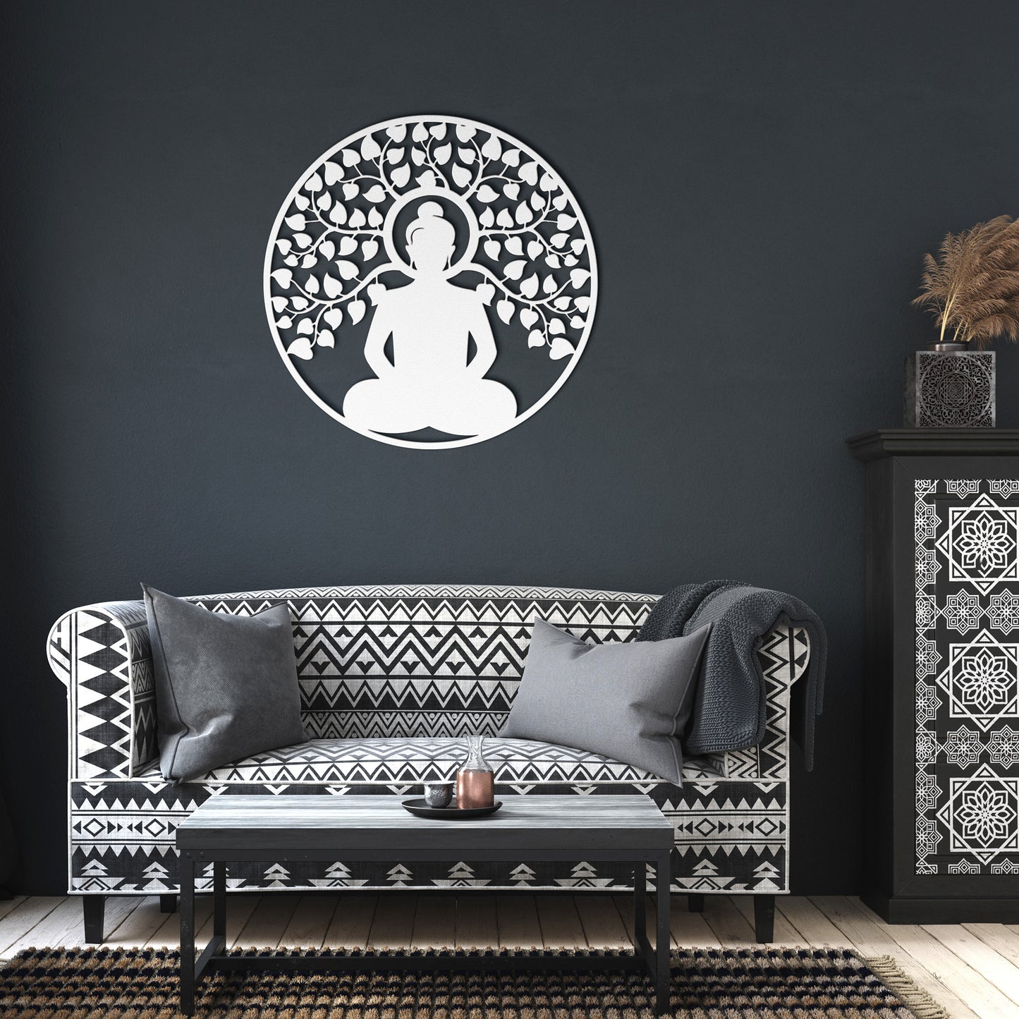 A wooden door with an arched window and brass handle is set in a brick wall. A round, powder-coated metal sign featuring the Buddhist Mandala Metal Art depicting a meditating figure under a tree and a potted plant are next to the door, adding charm to the home decor.