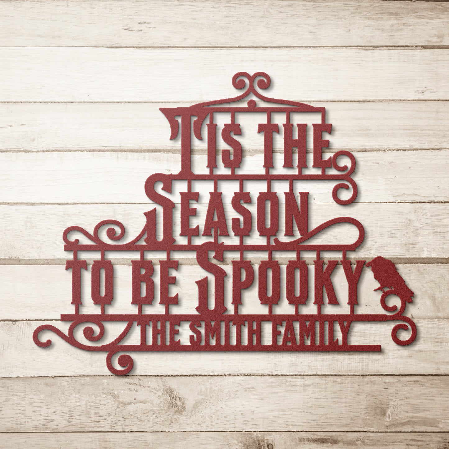 A brick wall with a wooden arched door and a Custom Halloween Metal Sign reading "Tis the season to be spooky." A potted plant with white flowers is placed on the left side of the door.
