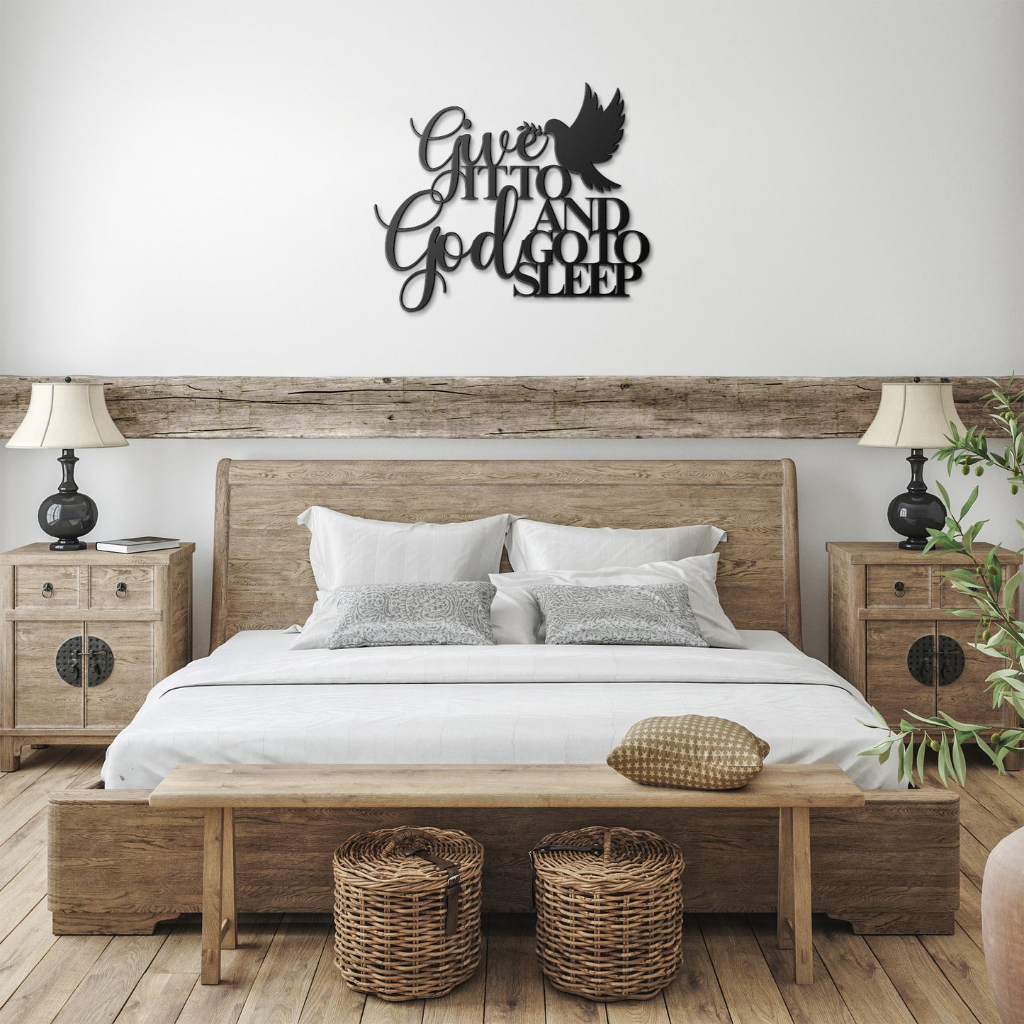 A rustic bedroom featuring a wooden bed, two nightstands with lamps, a bench, and wicker baskets. Above the bed hangs a "Give It To God And Go To Sleep" Christian Metal Sign — a perfect piece of bedroom wall art for adding a serene touch to your decor.