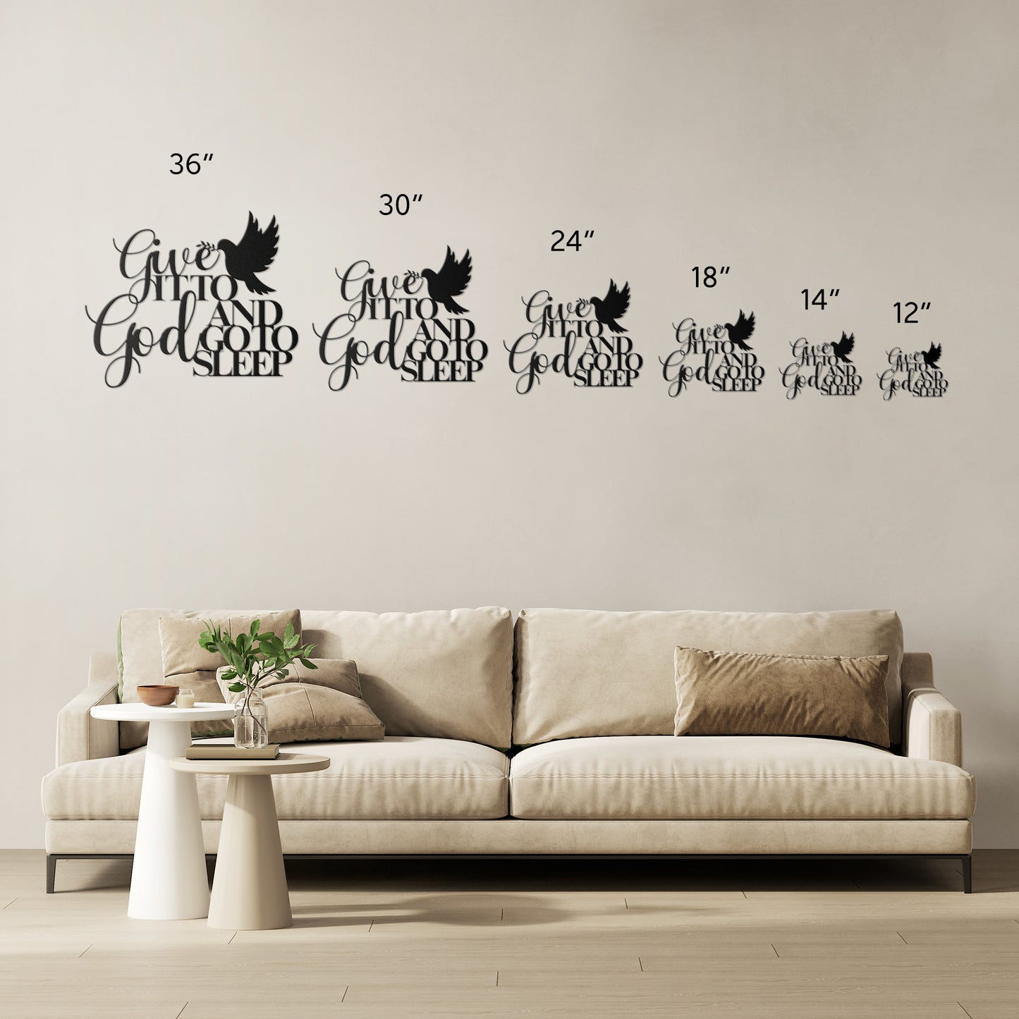 A living room with a beige sofa, plants, and nested tables. A Christian Metal Sign above the sofa reads "Give It to God and Go to Sleep," capturing the sentiment found in Christian bedroom wall art.