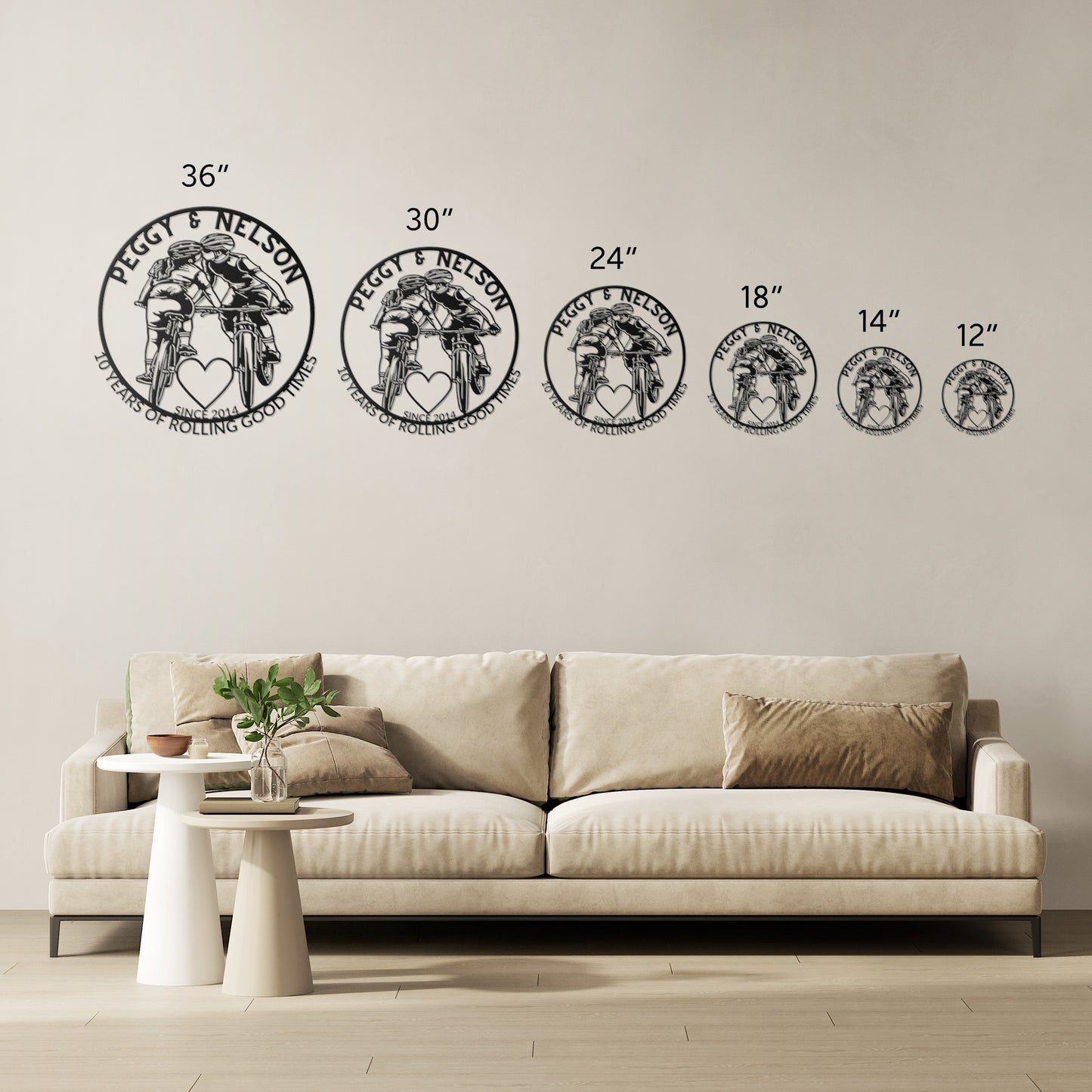 Personalized metal art of a cycling couple on mountain bikes with "Peggy & Nelson" elegantly displayed above a beige sofa.