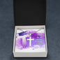 A ShineOn Fulfillment stainless steel cross necklace with ball chain on a purple watercolor background with the inscription "I can do all things through Christ!" inside a gift box.