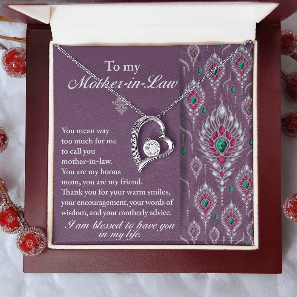 The "To Mother-In-Law, Words Of Wisdom - Forever Love Necklace" with a heart pendant is displayed in an open box. The accompanying message expresses gratitude towards a mother-in-law. Small decorative red berries surround the box, making this personalized gift truly special.
