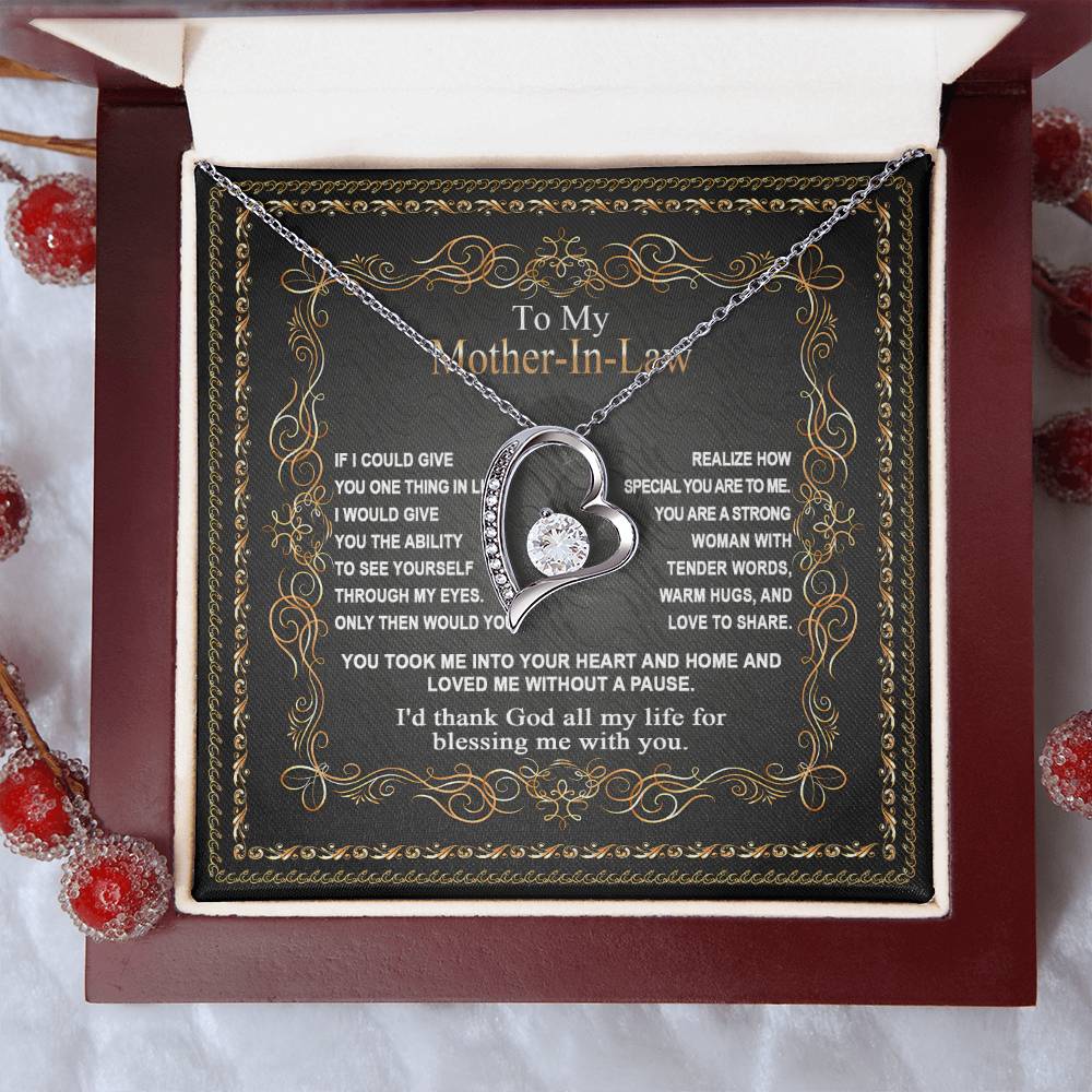 The "To Mother-In-Law, Through My Eyes - Forever Love Necklace" features a heart-shaped pendant with an embedded gemstone and comes elegantly presented in a gift box. The lid of the box is adorned with an ornate border and bears a heartfelt inscription for your Mother-In-Law, making it the perfect gift to express your love and appreciation. This Forever Love Necklace beautifully combines elegance and deep sentiment.