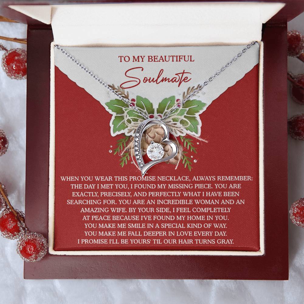 The Soulmate-At Peace - Forever Love Necklace features a rose-inspired design adorned with cubic zirconia accents, and is presented in a gift box. It includes a red card with a touching soulmate message, surrounded by holly sprigs.