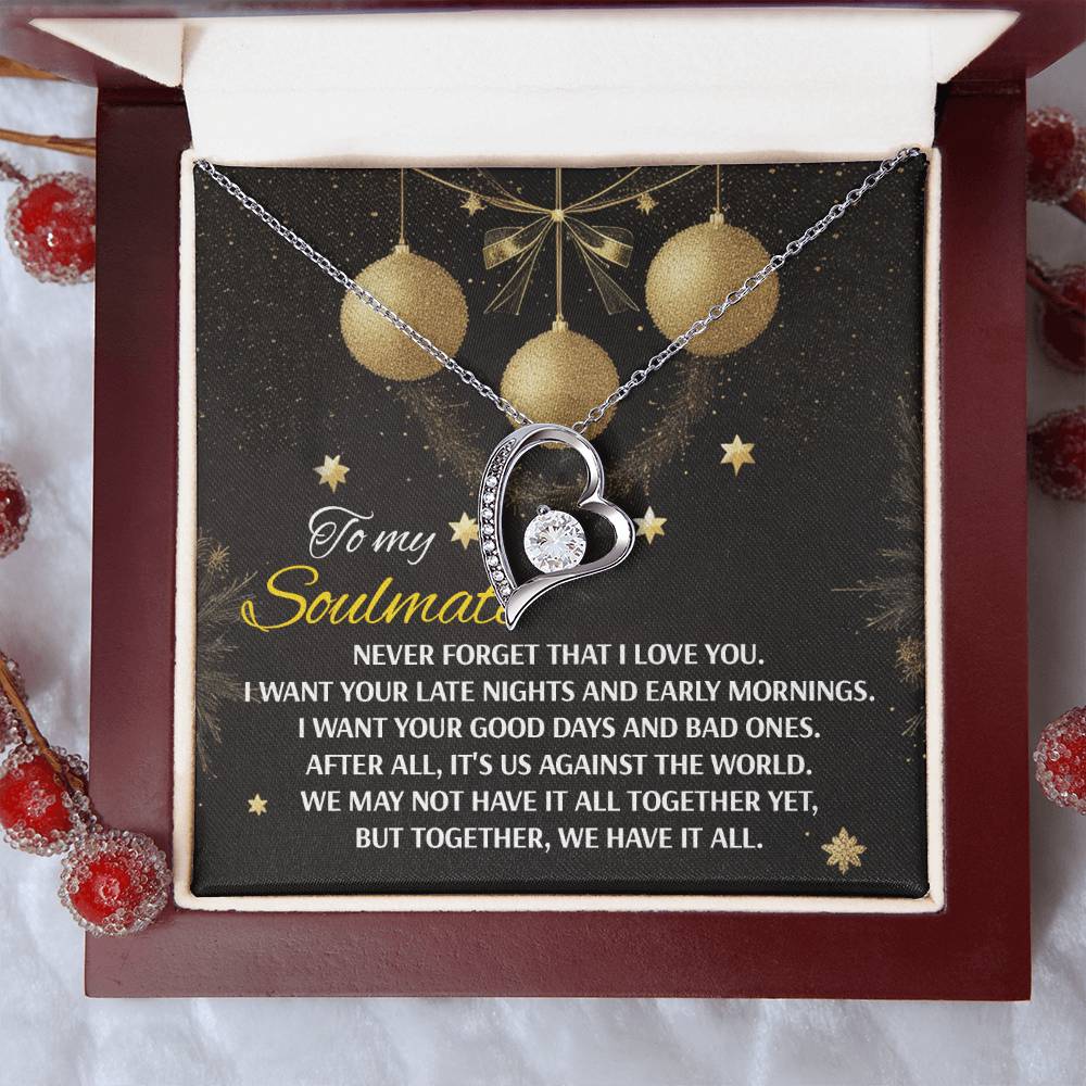 The "Soulmate-Have It All - Forever Love Necklace," heart-shaped and adorned with cubic zirconia stones, is elegantly presented in a gift box. The accompanying message starts with "To my Soulmate" and is set against a decorative background featuring hanging ornaments.