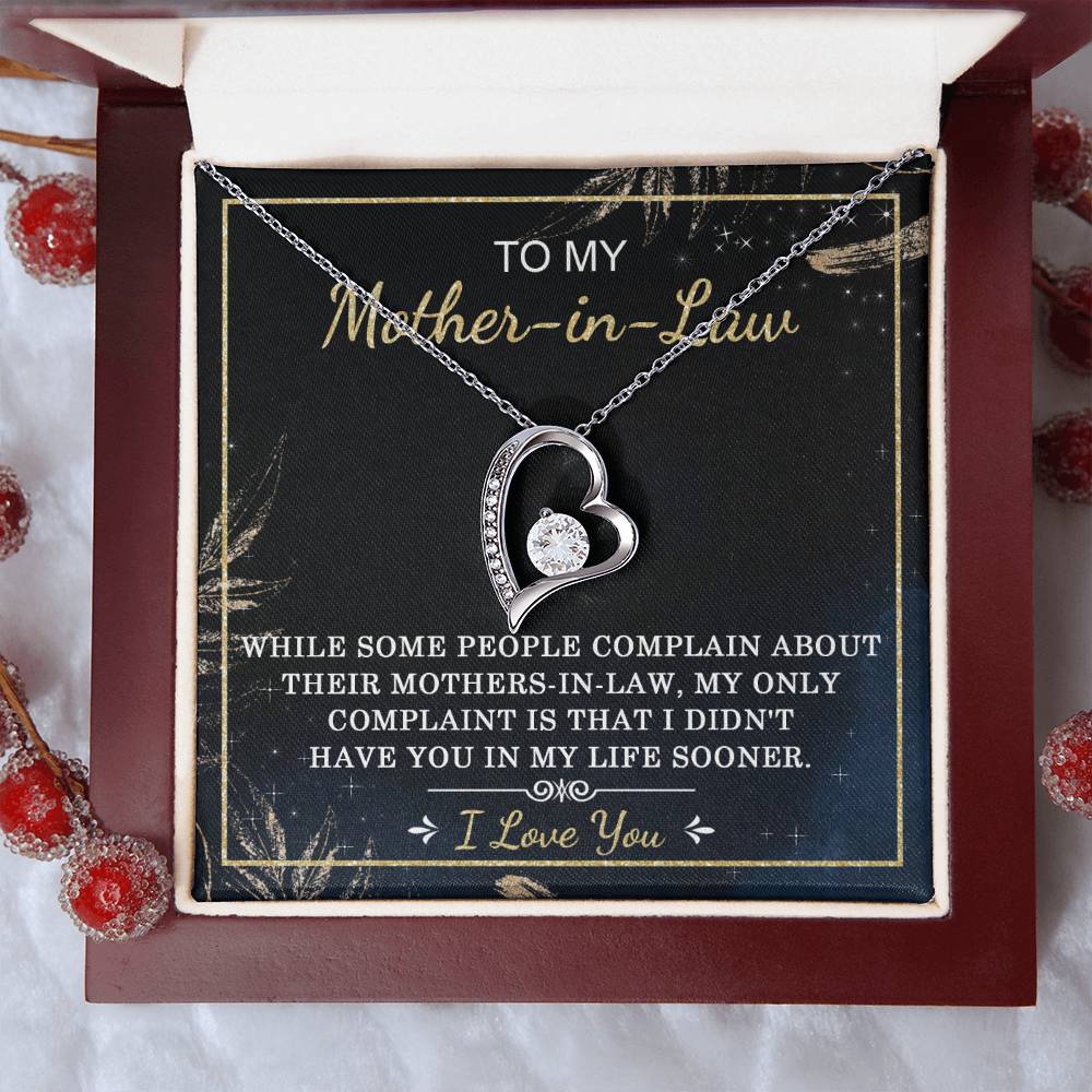 Introducing the "To Mother-In-Law, In My Life - Forever Love Necklace," featuring intertwined hearts with a sparkling gold finish, nestled in a beautiful gift box. The heartfelt message reads: "To my Mother-in-Law. While some people complain about their mothers-in-law, my only complaint is that I didn't have you in my life sooner. I love you." The necklace is adorned with cubic zirconia stones that add an extra touch of brilliance.