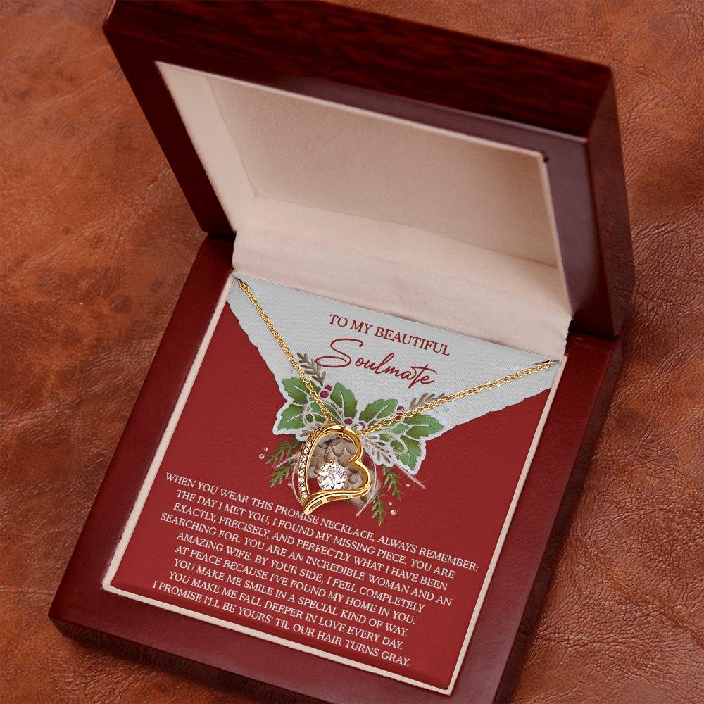 A gold finish necklace featuring a large CZ crystal pendant is elegantly displayed inside an open wooden box. The accompanying card reads, "To My Beautiful Soulmate," with a heartfelt message, beautifully encapsulating the essence of the Soulmate-At Peace - Forever Love Necklace and expressing deep devotion and affection.