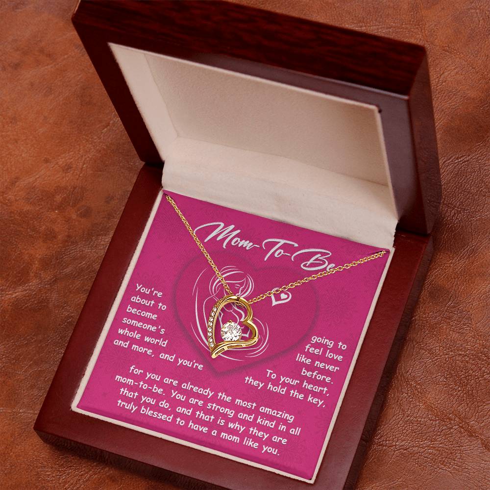 The "To Mom To Be, Someone's Whole World - Forever Love Necklace" is a stunning heart-shaped pendant adorned with a diamond and elegantly encased in a beautiful box. The box includes a card that reads "Mom-To-Be" along with a heartfelt message celebrating the strength and love of motherhood. This personalized gift is perfect for any expectant mother.