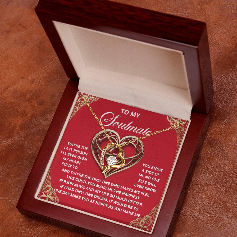 The Soulmate-The Only One - Forever Love Necklace showcases a gold and silver heart design topped with a sparkling crystal, presented in an open wooden box with a romantic inscription—an ideal gift to cherish forever.