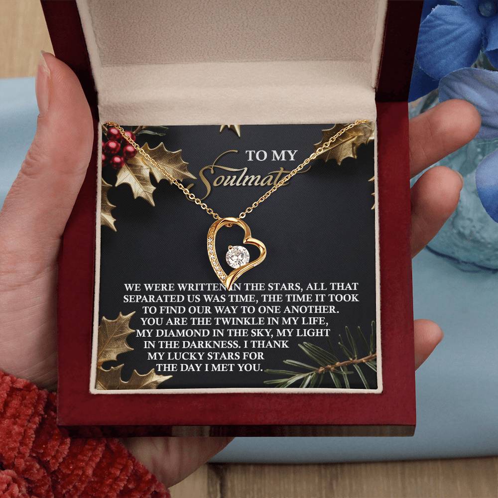 A hand holds an open jewelry box revealing the Soulmate-In The Stars - Forever Love Necklace and a card that reads "To my soulmate.