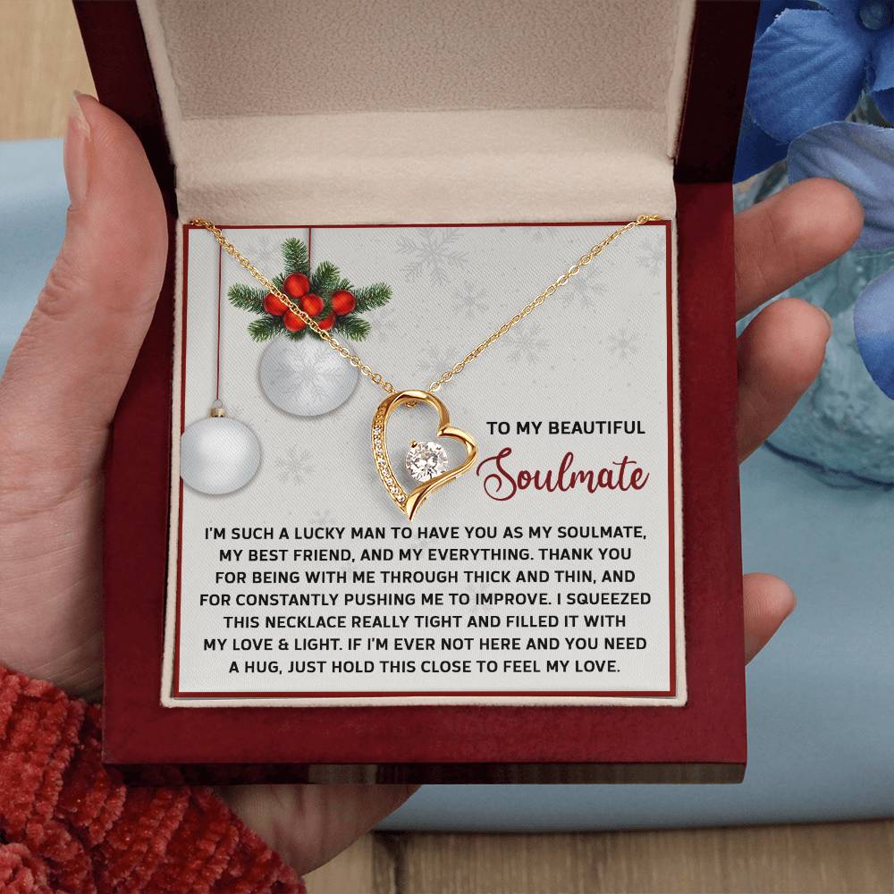 A hand displays an open jewelry box with the Soulmate-Feel My Love - Forever Love Necklace on a message card, conveying love and appreciation to a soulmate.
