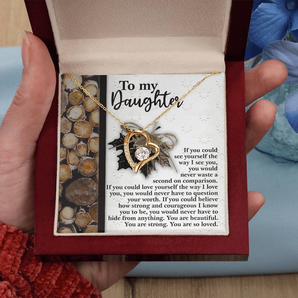 The Daughter-Holds For You 2 - Forever Love Necklace is a heart-shaped pendant featuring a cubic zirconia stone, elegantly packaged in a box with a heartfelt message card for your daughter.