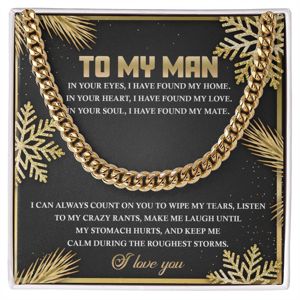 The "My Man-Found My Home - Cuban Link Chain" is a black and gold decorative sign adorned with a Cuban Link chain and gold snowflake designs at the corners. It conveys a heartfelt message to a man, expressing love, support, and appreciation.