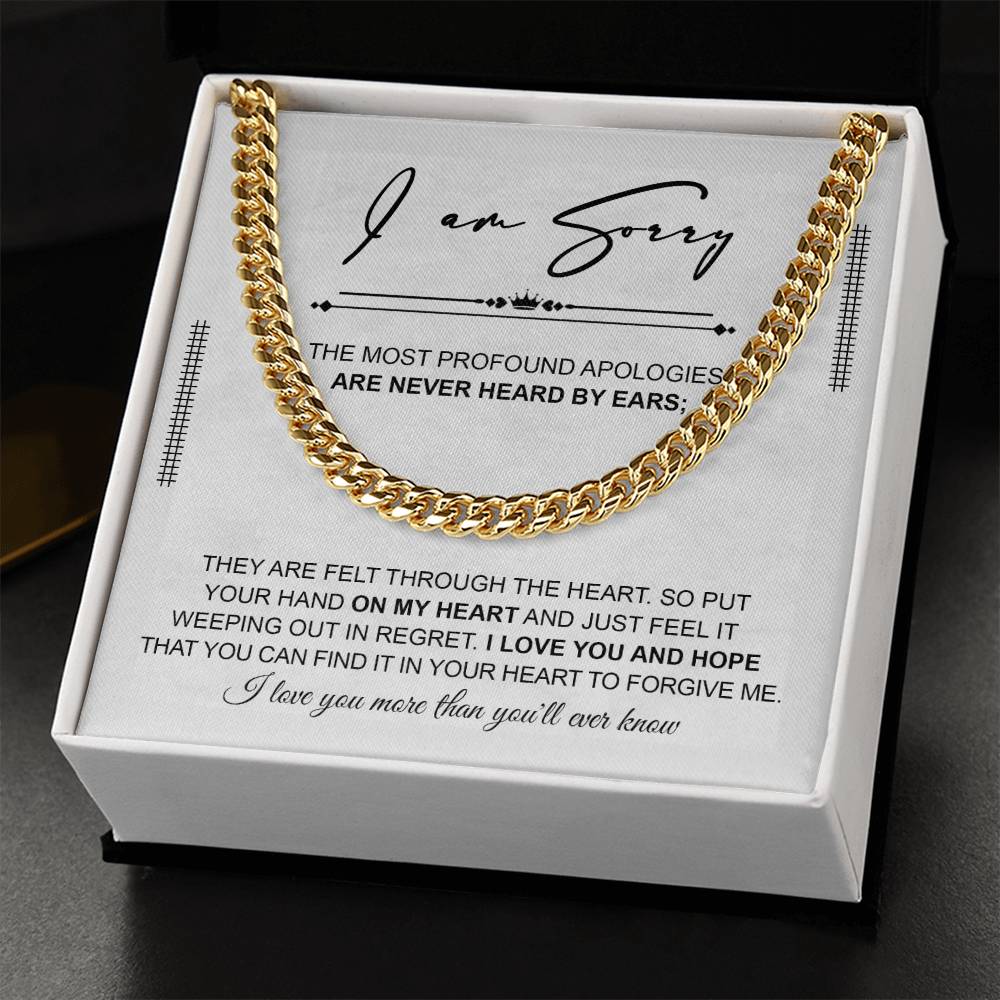 A polished stainless steel Cuban Link Chain necklace with an apology note. The note reads: "I am sorry. The most profound apologies are never heard by ears; they are felt through the heart... I love you and hope you can forgive me.