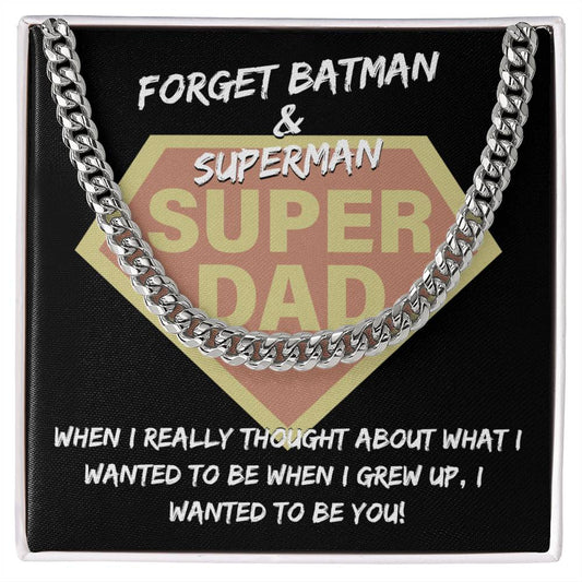 "To Dad, To Be You" emblem resembling a superhero logo, framed by a Cuban link chain, with the text "forget batman & superman, when I really thought about what i wanted to be when I