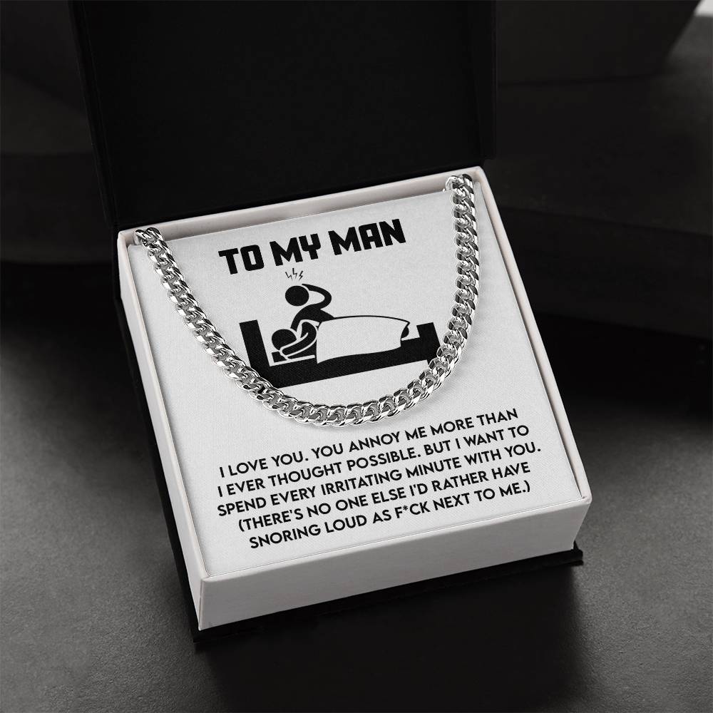 The My Man-Next To Me - Cuban Link Chain is showcased in an open black box with a card displaying a cartoon of a sleeping couple and the message "TO MY MAN" alongside a humorous love note about snoring and irritation.