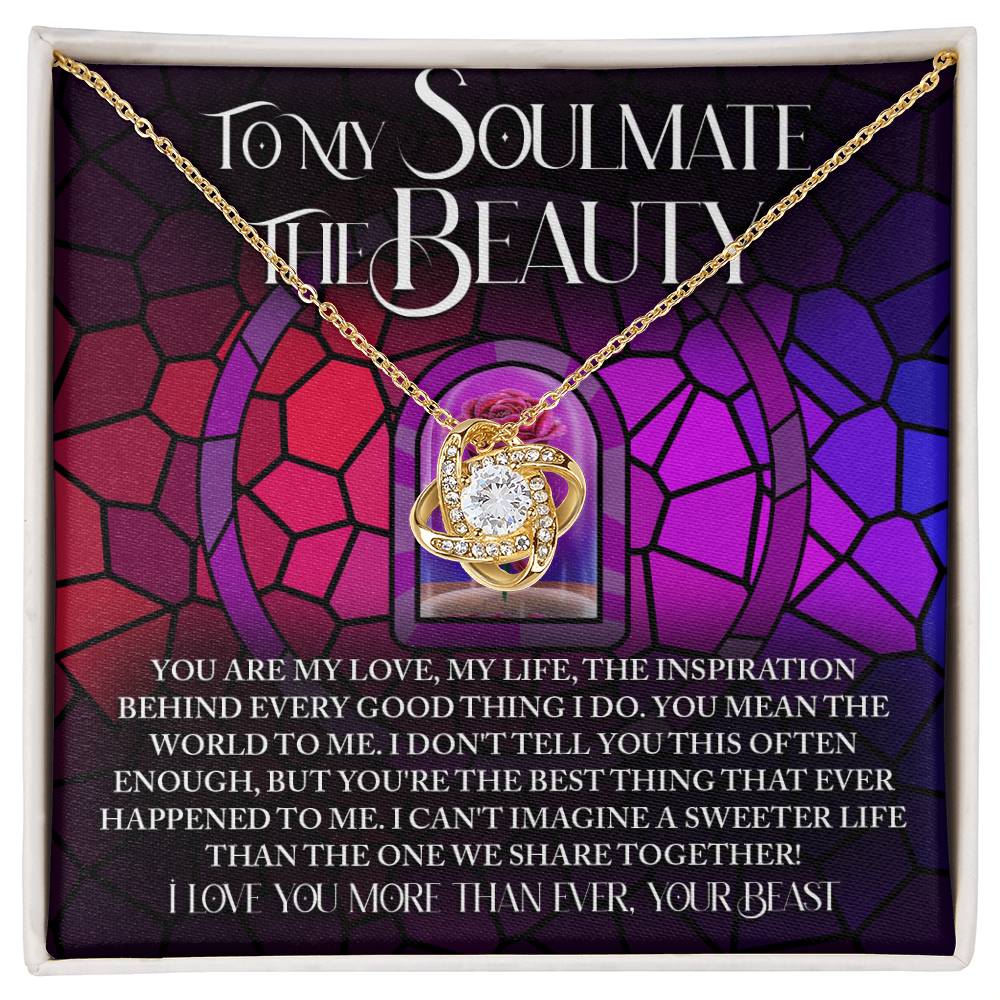 The Soulmate-Sweeter Life Love Knot Necklace showcases a ring and cubic pendant with sparkling zirconia crystals on a decorative card titled "To my soulmate," featuring a romantic message against a geometric red and purple background, making it an ideal personalized gift.