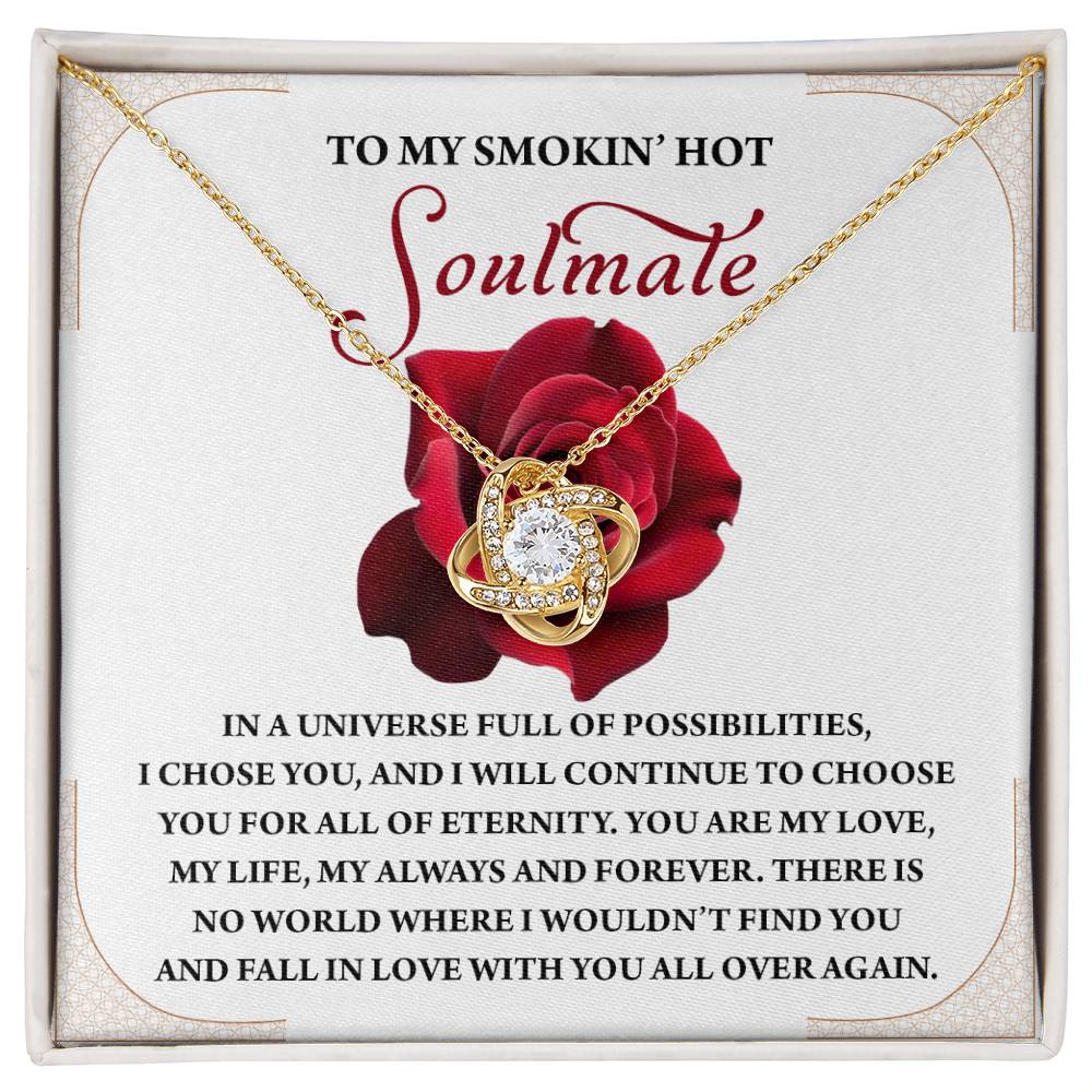 The Soulmate-Over Again Love Knot Necklace includes a heart pendant embellished with cubic zirconia on a romantic card with a rose and the message "To My Smokin' Hot Soulmate," available in white or yellow gold.