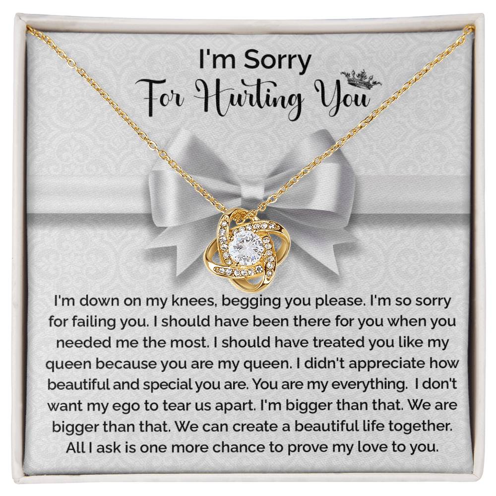 The "Sorry-My Queen - Love Knot Necklace" features a knot-shaped pendant adorned with cubic zirconia crystals and comes in a gift box that includes an apology message, expressing regret and asking for forgiveness and another chance to prove love.