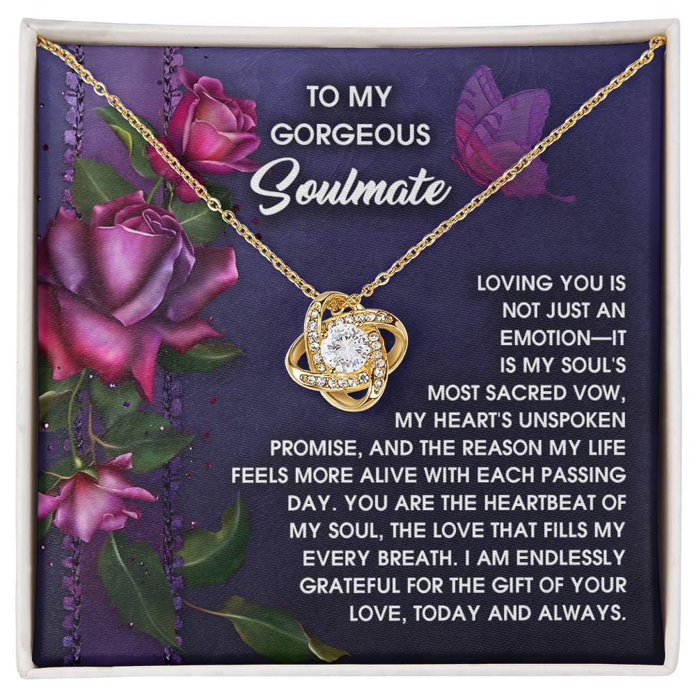The Soulmate-Unspoken Promise Love Knot Necklace features a central stone framed by cubic zirconia crystals on a floral backdrop, making it the ideal personalized gift for your gorgeous soulmate.