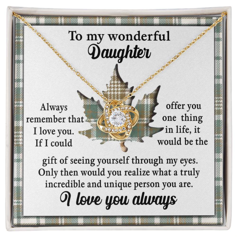 The Daughter-Through My Eyes - Love Knot Necklace, adorned with cubic zirconia crystals and available in a white gold or yellow gold finish, features a heart-shaped pendant against a background with heartfelt messages to a daughter, including sayings about love and appreciation.