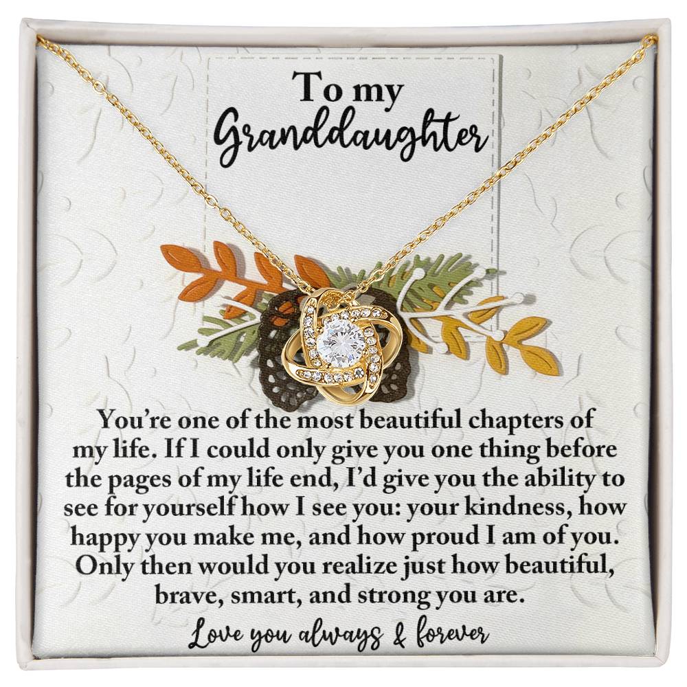 The Granddaughter-How Beautiful - Love Knot Necklace showcases an intertwined design set against a floral backdrop and is embellished with sparkling Cubic Zirconia, delivering a heartfelt message to your granddaughter, elegantly presented in a jewelry box.