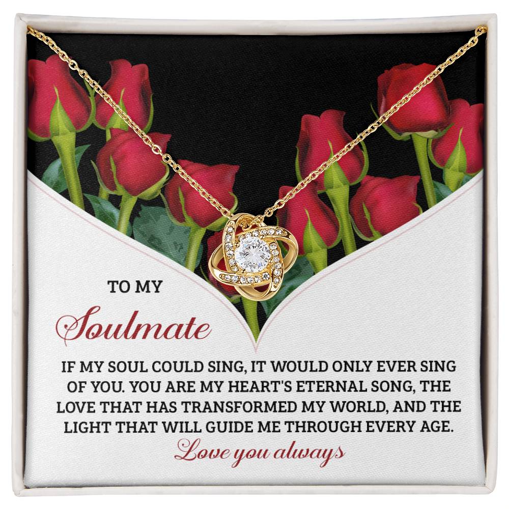 The Soulmate-Eternal Song Love Knot Necklace sparkles among red roses, with each cubic zirconia symbolizing the unbreakable bond shared with a soulmate—a true testament to eternal love.