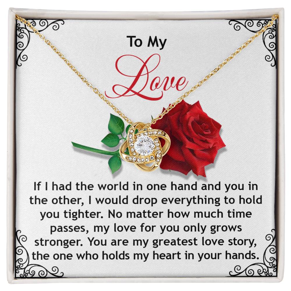 The Soulmate-In Your Hands Love Knot Necklace with a rose and cubic zirconia is displayed on a card saying, "To My Love. If I had the world in one hand..." expressing growing love and devotion.