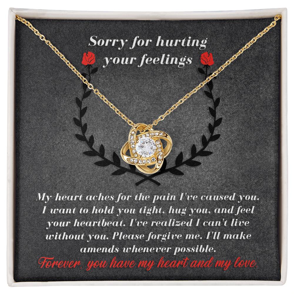 The Sorry-Make Amends - Love Knot Necklace, featuring a heart-shaped pendant adorned with cubic zirconia crystals, is showcased with an apology message stating, "Sorry for hurting your feelings," and a heartfelt note expressing regret and love. This personalized gift eloquently conveys your sincere emotions.