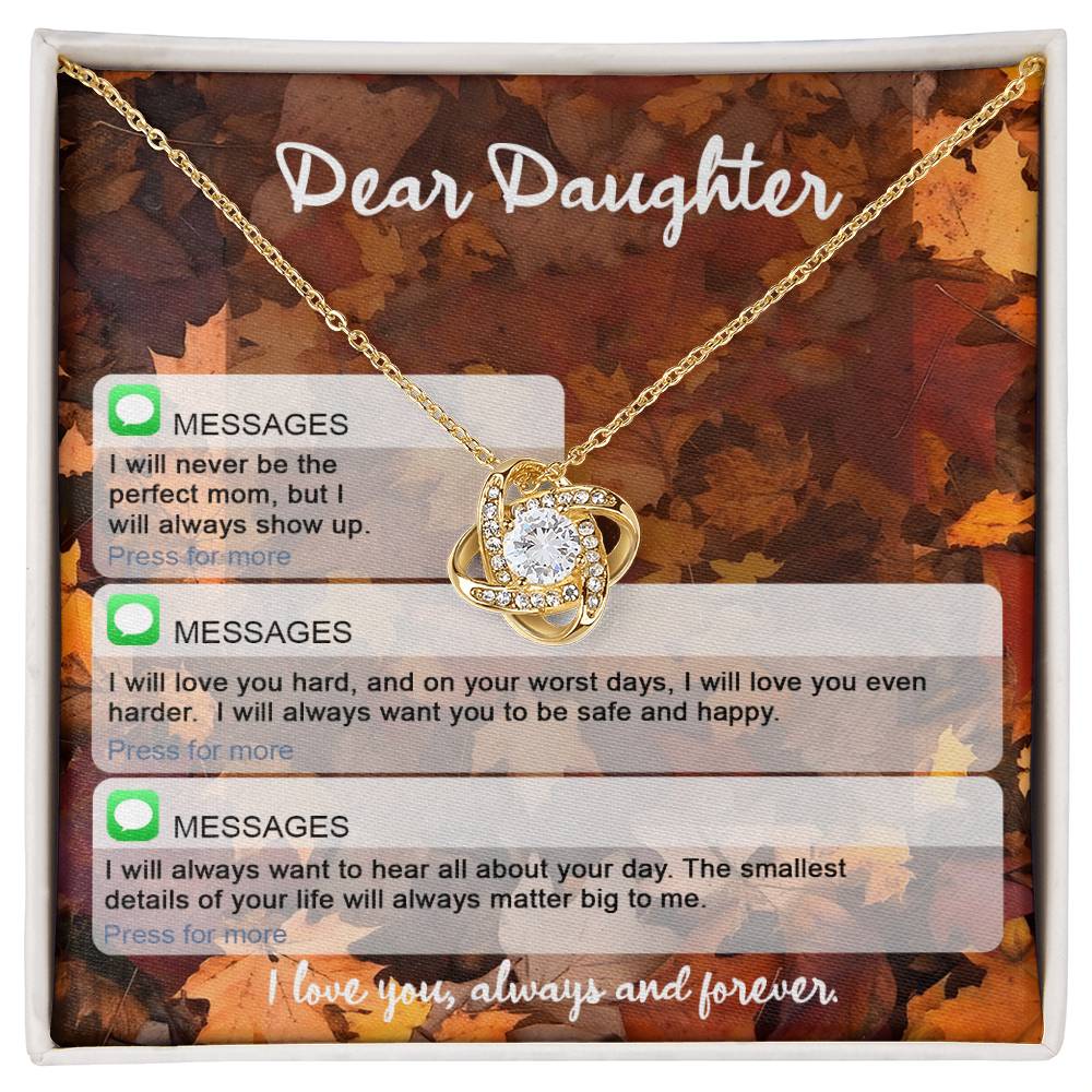 A Daughter-Perfect Mom - Love Knot Necklace with a heart pendant and embedded cubic zirconia crystals rests in a gift box adorned with the words "Dear Daughter" and loving messages from a parent.