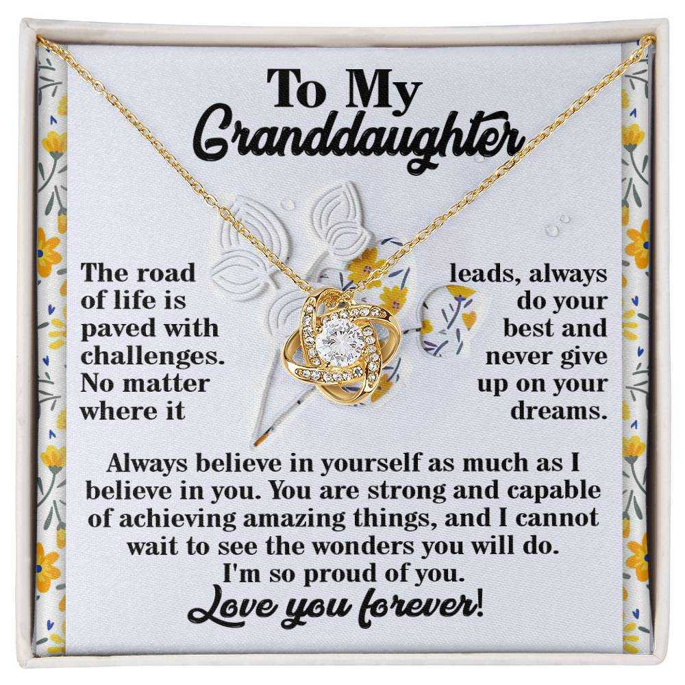 Presented on a card featuring an inspirational message for your granddaughter, the Granddaughter-On Your Dreams - Love Knot Necklace is crafted from 14k White Gold and beautifully embellished with sparkling Cubic Zirconia, representing an enduring bond and infinite love.