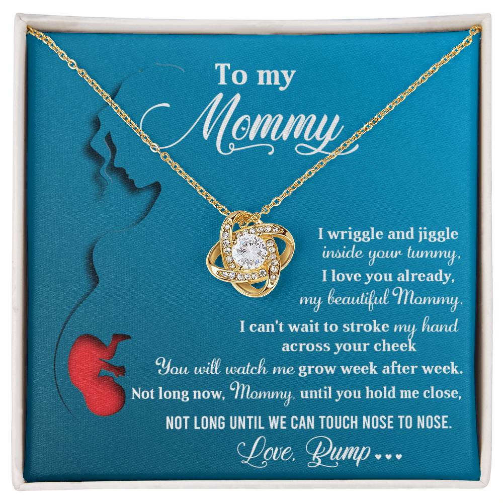 The To Mom To Be, Nose To Nose - Love Knot Necklace, embellished with cubic zirconia crystals, is presented on a card featuring a poem titled "To my Mommy" from "Love, Bump," and includes an illustration of a pregnant woman with a fetus silhouette.