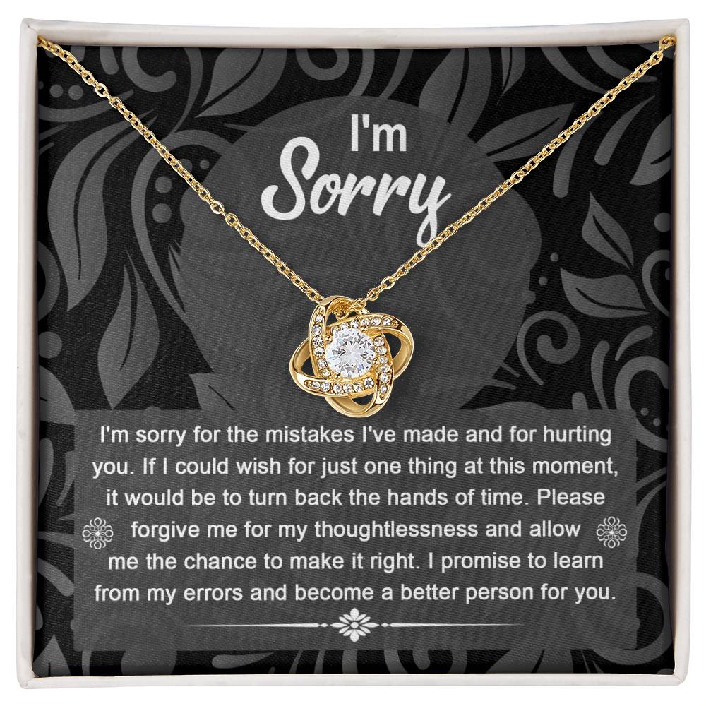 The Sorry-Just One Thing - Love Knot Necklace with intertwined loops is elegantly displayed in a box, featuring an apology message on the inside lid that reads: "I'm sorry. I'm sorry for the mistakes I've made and for hurting you...