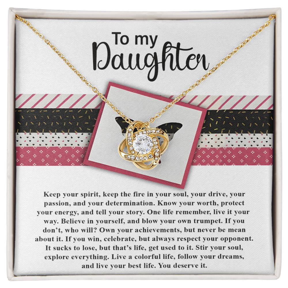 The "Daughter-Keep The Fire - Love Knot Necklace" features a beautiful gold heart and knot pendant on a card with an inspirational message addressed "To my Daughter." The necklace emphasizes themes of self-belief, determination, and living life to the fullest. Embellished with sparkling cubic zirconia crystals, this personalized gift is sure to be cherished forever.