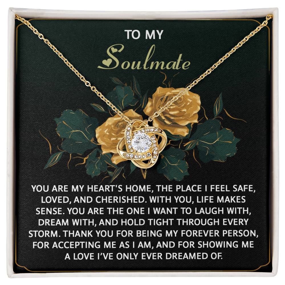 The Soulmate-Forever Person - Love Knot Necklace showcases a gold finish with a central sparkling gem, accented by cubic zirconia crystals. It features yellow roses and includes a heartfelt message for your soulmate.