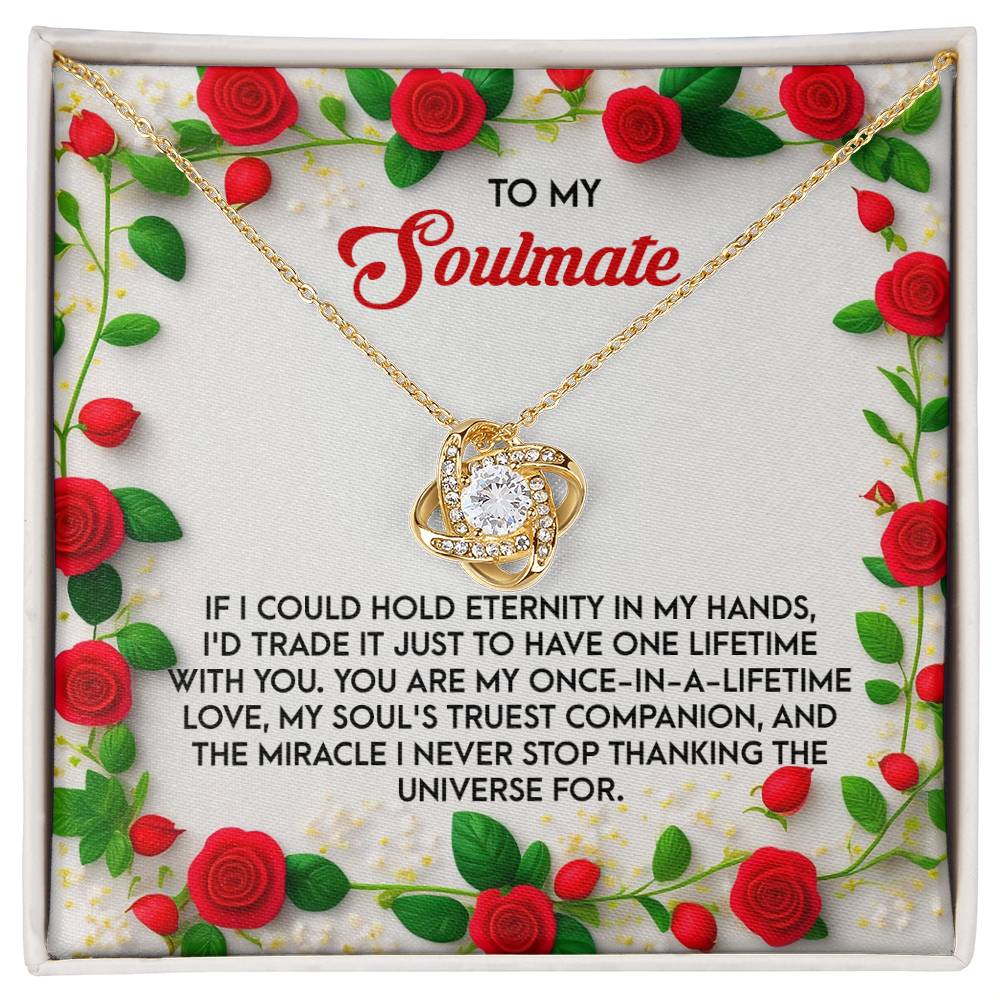 The Soulmate-One Lifetime - Love Knot Necklace, with a heart-shaped pendant embellished with cubic zirconia crystals, comes in a gift box. The white gold finish matches the red rose designs on the box, which includes a heartfelt love message.