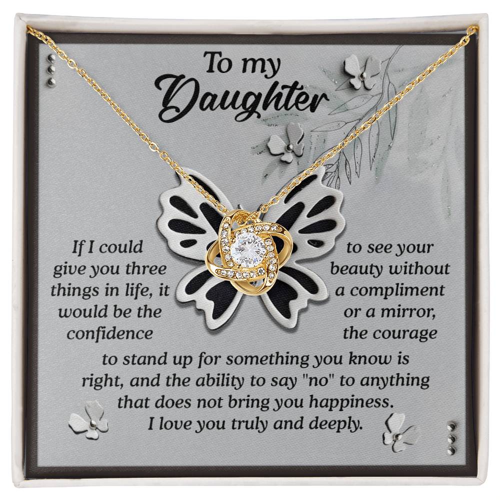 The Daughter-See Your Beauty - Love Knot Necklace is presented on a card that conveys heartfelt love and life advice from a parent to their daughter. The pendant, adorned with sparkling cubic zirconia crystals, adds an elegant touch to this perfect personalized gift.