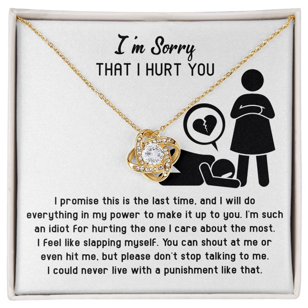 A gold Love Knot necklace adorned with Cubic Zirconia Crystals is displayed in a box. The box reads "I'm Sorry-Stop Talking THAT I HURT YOU," followed by a heartfelt message apologizing for causing pain and expressing a desire to make amends.