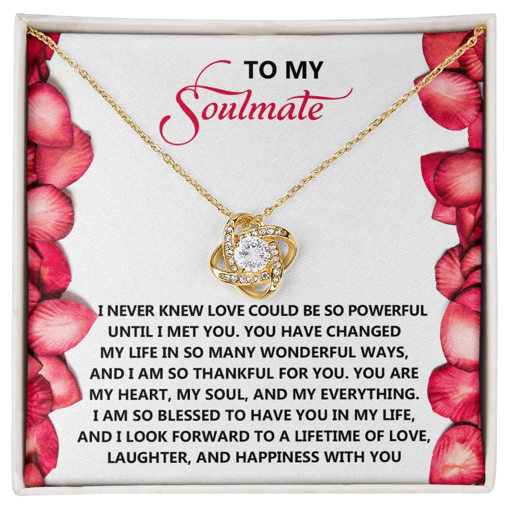 The Soulmate-Until I - Love Knot Necklace, with a diamond heart pendant, is beautifully showcased on a card with a romantic message and rose petals, making it an ideal personalized gift.