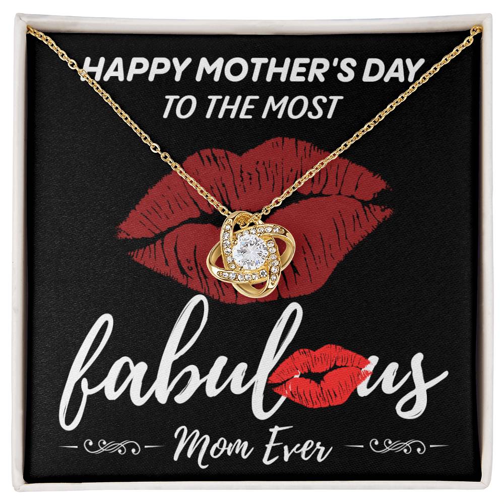The "To Mom, The Most Fabulous - Love Knot Necklace," featuring a central gem and surrounded by cubic zirconia crystals, is elegantly presented in a box adorned with red lip illustrations and the heartfelt message, "Happy Mother's Day to the most fabulous Mom ever.