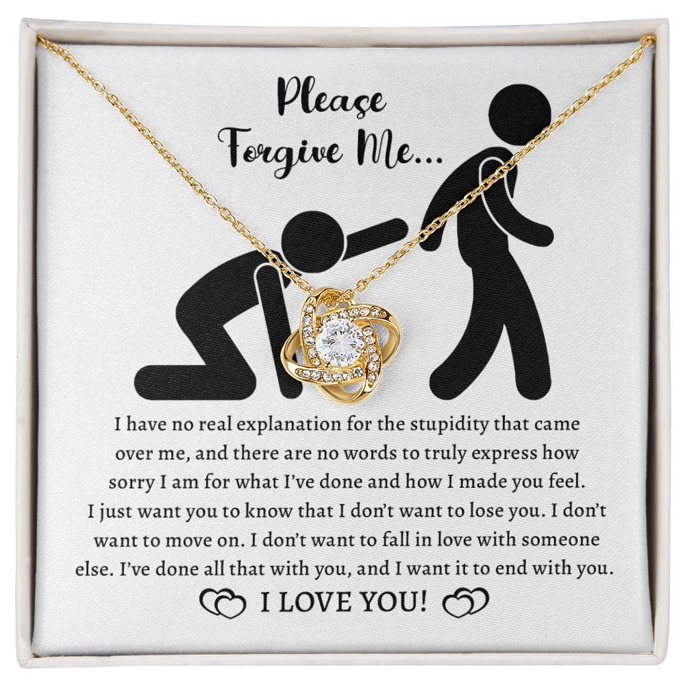 The Sorry-Made You Feel - Love Knot Necklace in 14k white gold and a card with the message "Please Forgive Me... I have no real explanation for the stupidity that came over me... I love you!" is shown. The necklace features intertwined hearts adorned with cubic zirconia crystals.