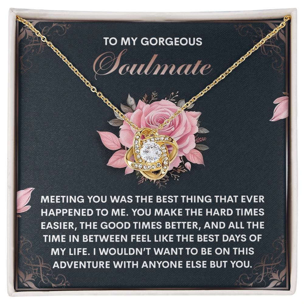 The Soulmate-Best Days Love Knot Necklace is beautifully displayed with a heart pendant and cubic zirconia crystals, set against a floral background. The box reads, "To my gorgeous soulmate," with a sentimental message underneath, making it a perfect personalized gift.