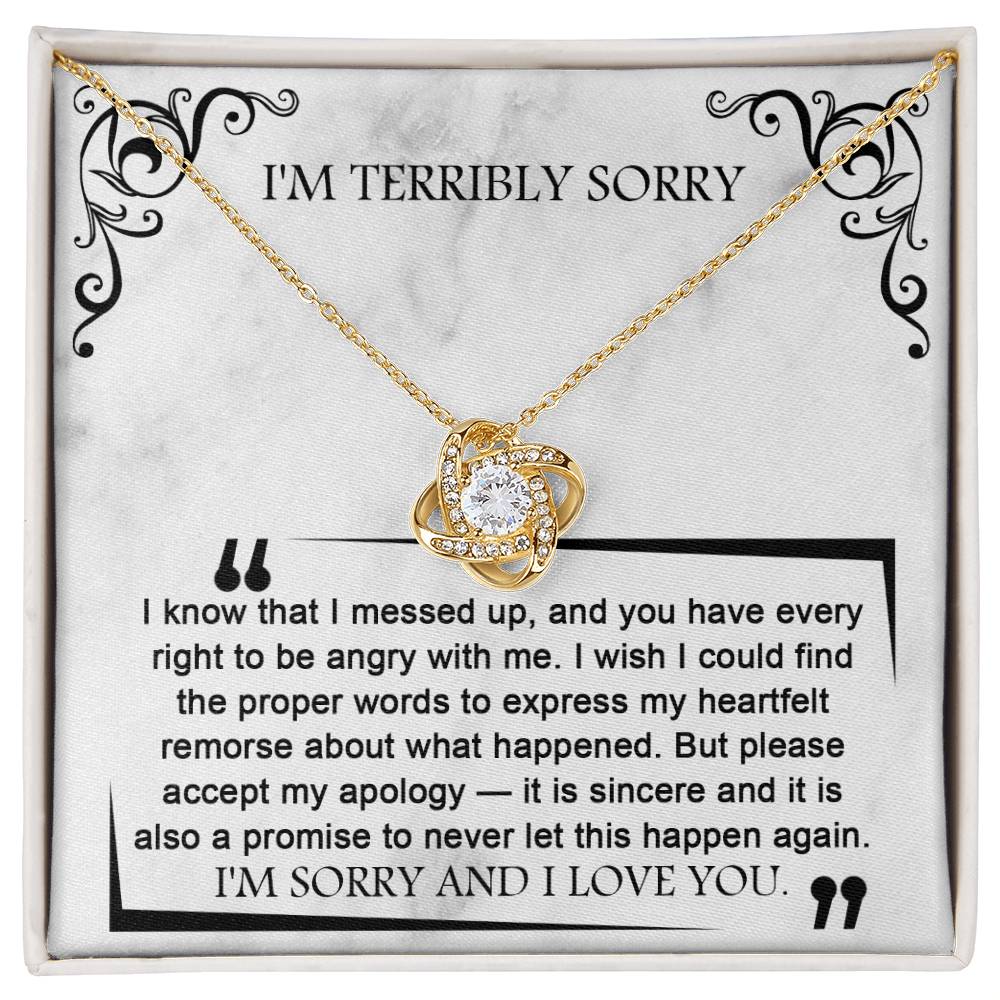The Sorry-Angry With Me - Love Knot Necklace, featuring a heart-shaped pendant adorned with premium cubic zirconia crystals, is elegantly presented on a card that says "I'M TERRIBLY SORRY" and includes a sincere apology message below.