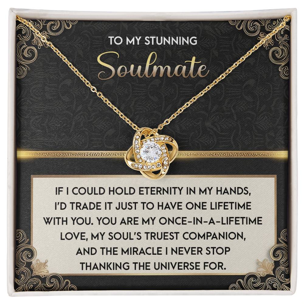 The Soulmate-Truest Companion Love Knot Necklace features a heart-shaped pendant with cubic zirconia crystals and comes on a decorative card with a romantic message for your "stunning soulmate," expressing gratitude and love in sparkling detail.