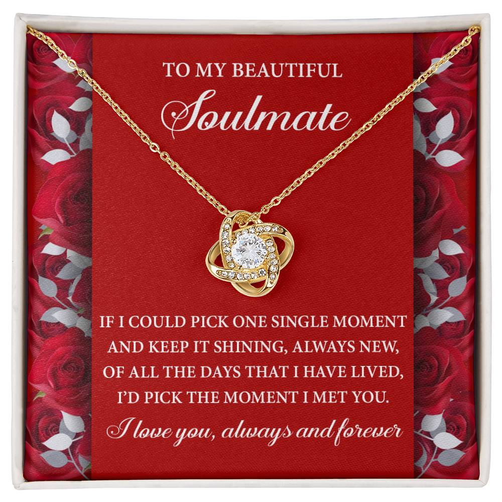The "Soulmate-Keep It Shining - Love Knot Necklace" features a gold finish and cubic zirconia crystals, elegantly displayed in a box with a romantic message for your soulmate against a red rose background.