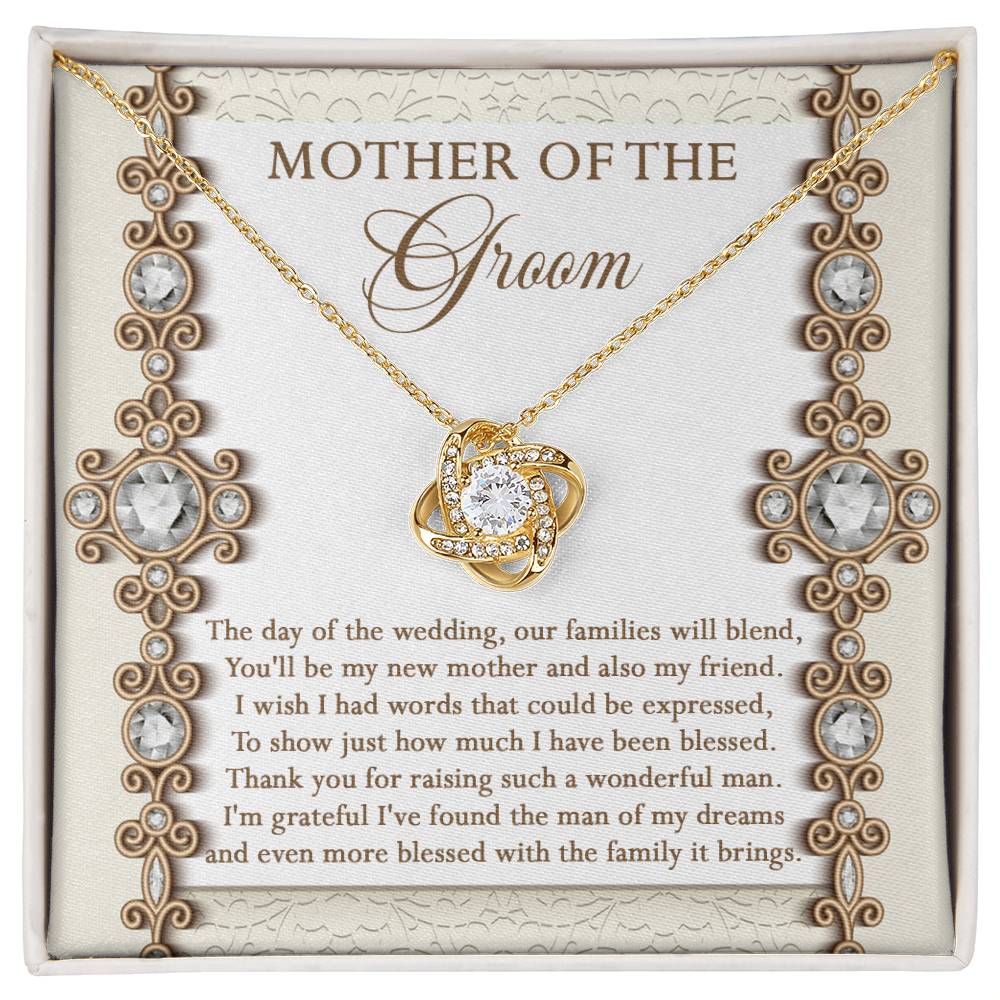 To Mom Of Groom, New Mother - Love Knot Necklace with an interlocking heart pendant, adorned with cubic zirconia crystals, on a card reading: “Mother of the Groom” and a heartfelt message appreciating the groom's mother. Available in white gold or yellow gold finish.