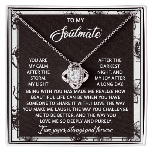 The Soulmate-Deeply And Purely Love Knot Necklace is a personalized gift showcasing an intertwined design with a silver heart. It features cubic zirconia crystals and comes on a printed card with a touching message about love and companionship.